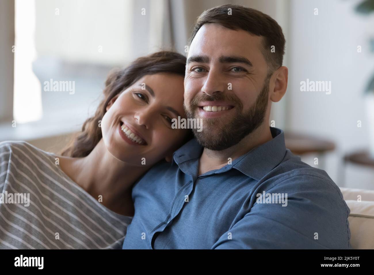 Happy young adult married couple home head shot portrait Stock Photo