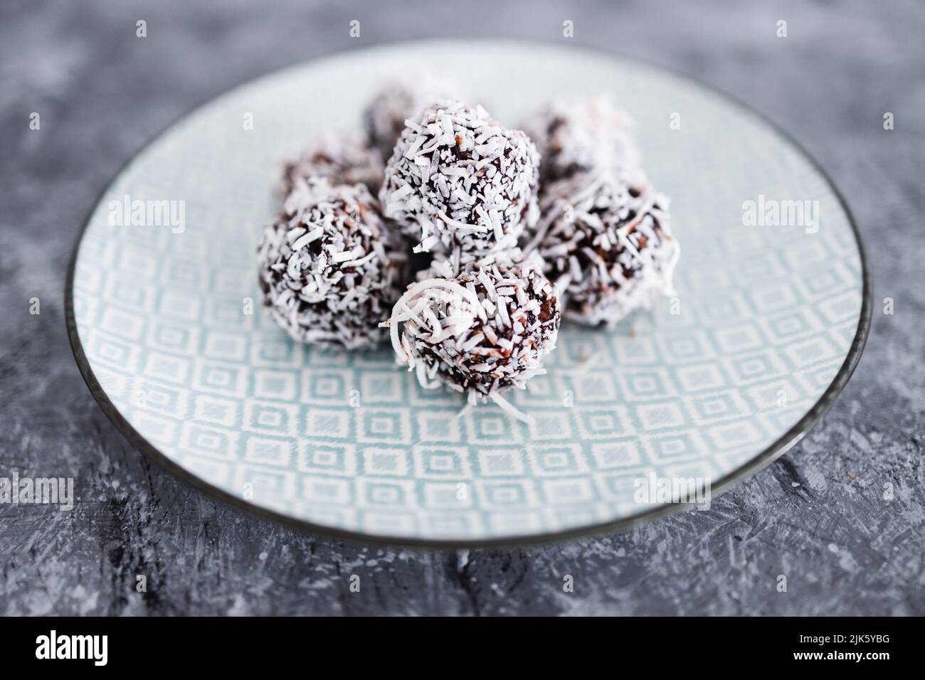 plantbased chocolate and nut butter bliss balls with coconut topping