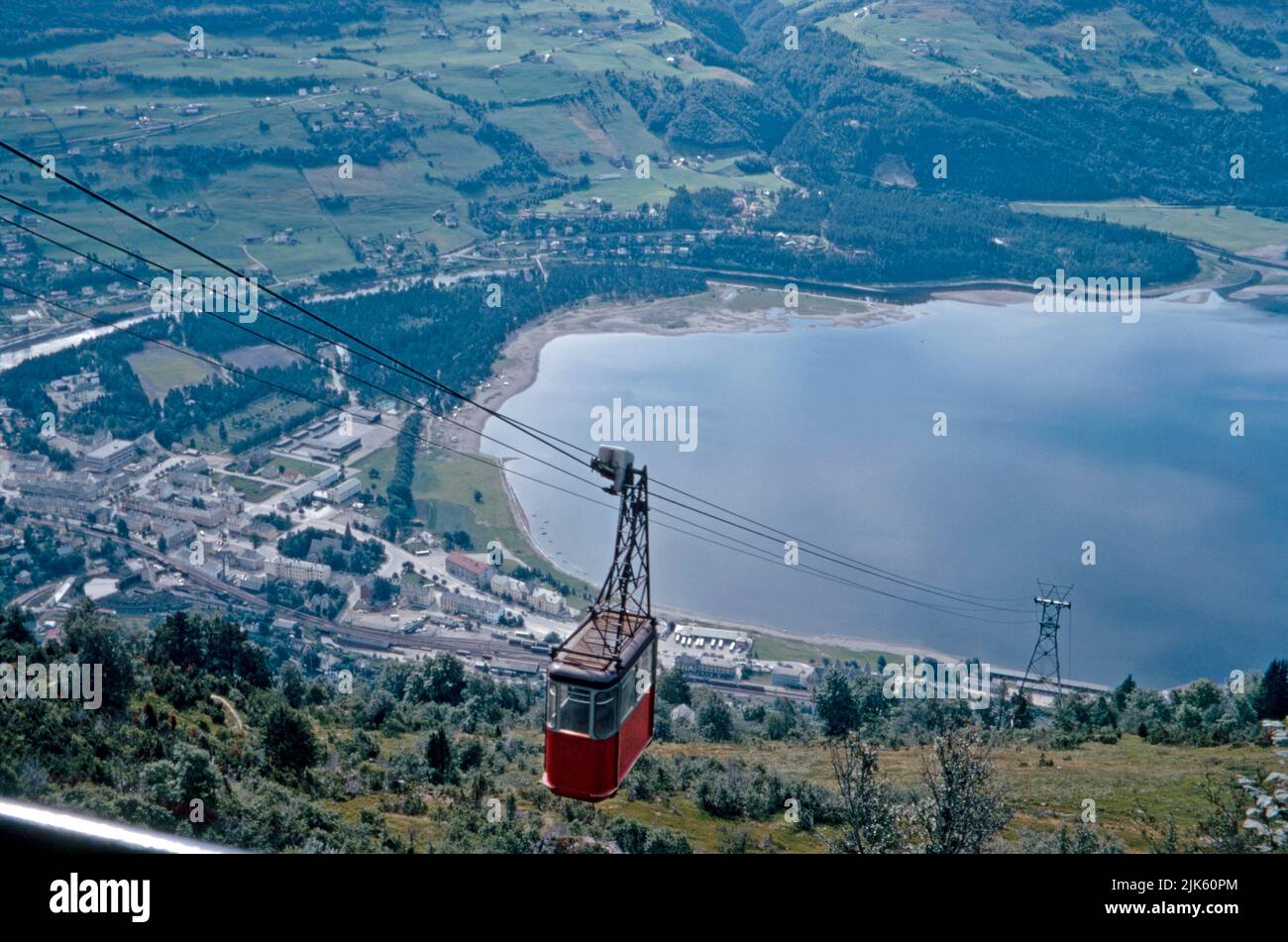 The cable car on its journey up to Mount Hanguren, Voss, Vestland, Norway in 1970. The resort of Voss is on the shore of Vangsvatnet lake. Skiing is the main activity in winter, in the summertime hiking, bike riding and water sports are popular. A new, replacement ride up the mountain, the Voss Gondol opened in 2019. It is largest mountain gondola in Northern Europe. This image is from an amateur 35mm colour transparency – a vintage 1970s photograph. Stock Photo