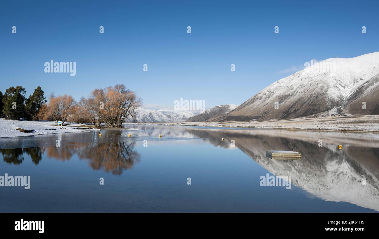 Snow covered mountains reflected in Lake Camp, Ashburton Lakes region, Canterbury. Stock Photo