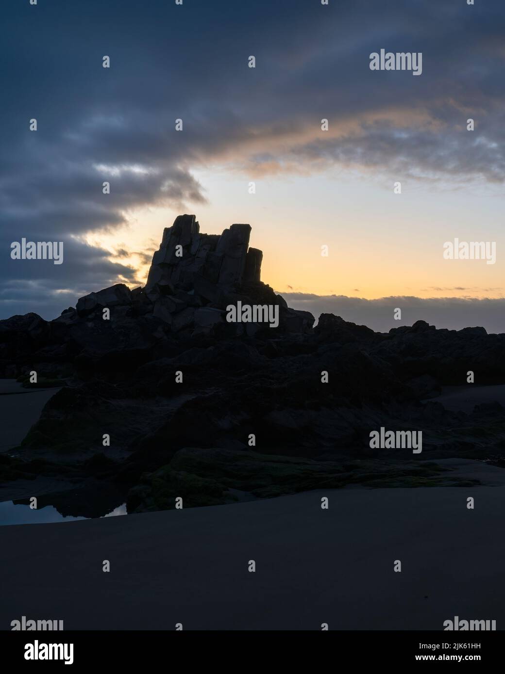 Silhouette image of Shag Rock, also known as Rapanui, Christchurch. Vertical format. Stock Photo