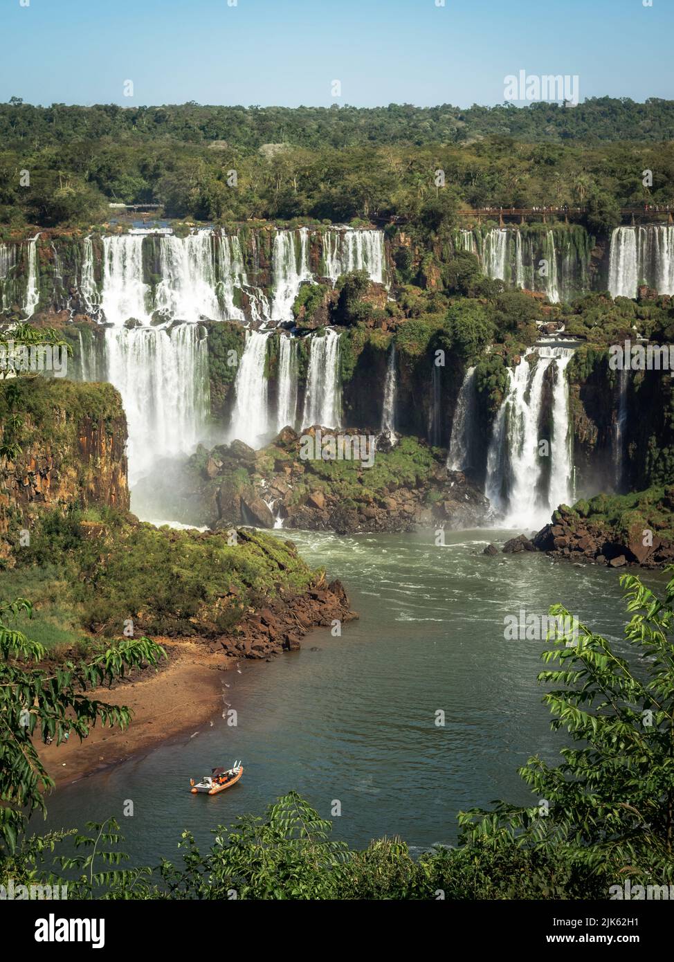 Tour boat exploring Iguazu Falls on the border of Brazil and Argentina. Stock Photo