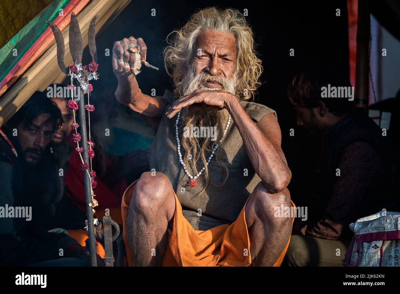 Indian holy man Amar Bharati Urdhavaahu, who has kept his arm raised for over 40 years in honour of Hindu God Shiva, at Kumbh Mela Festival in India. Stock Photo