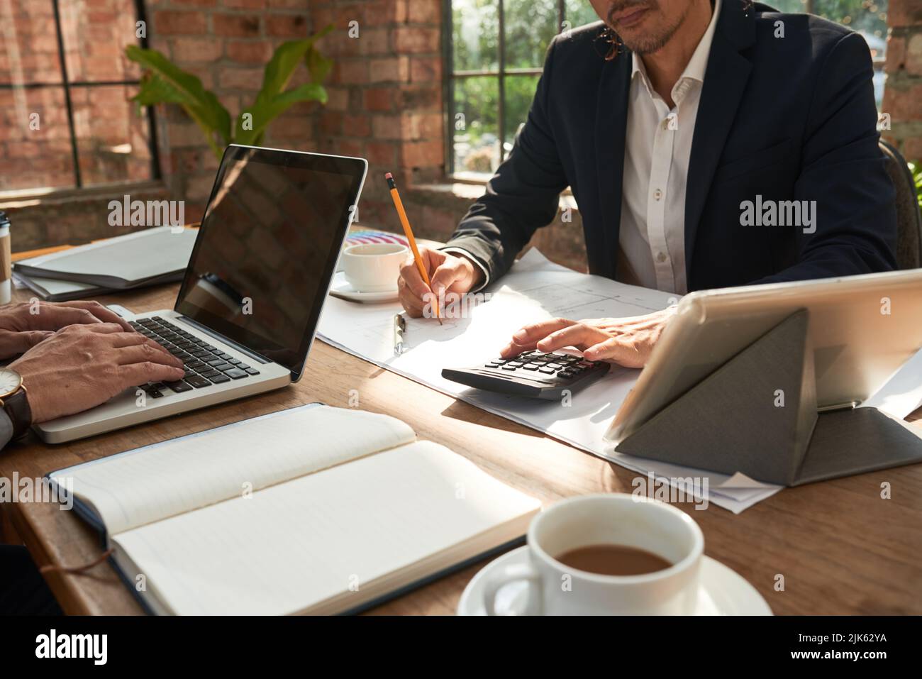 Architects working on construction project in office Stock Photo