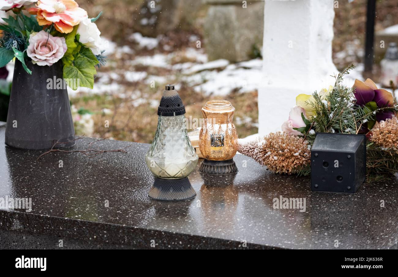 Old rural cemetery in winter. Neglected graves with snow in the old