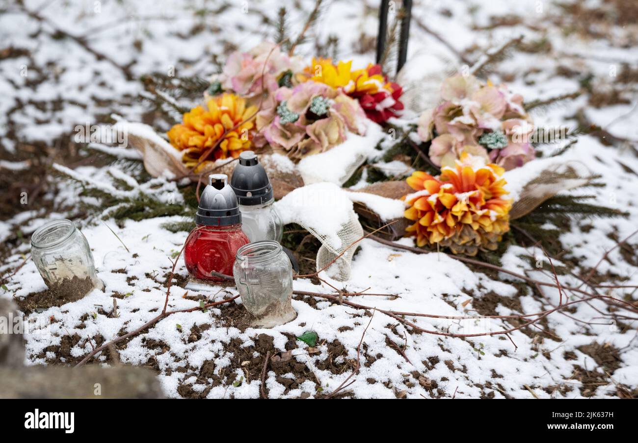 Old rural cemetery in winter. Neglected graves with snow in the old