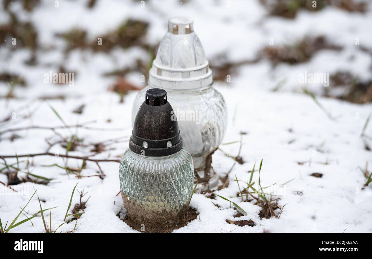 Old rural cemetery in winter. Neglected graves with snow in the old