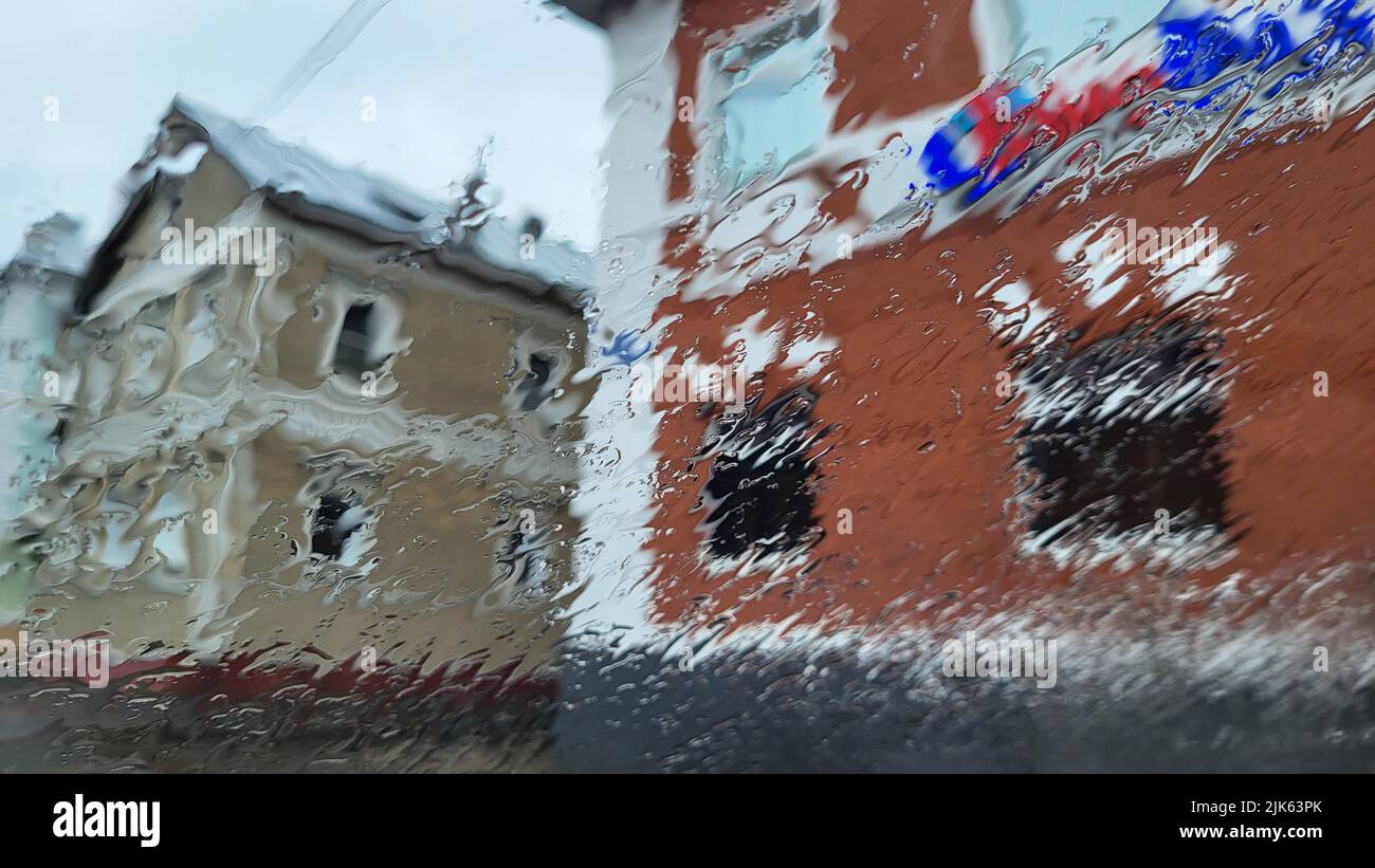Raindrops on window glass. Selective focus. Rainy city background Stock Photo