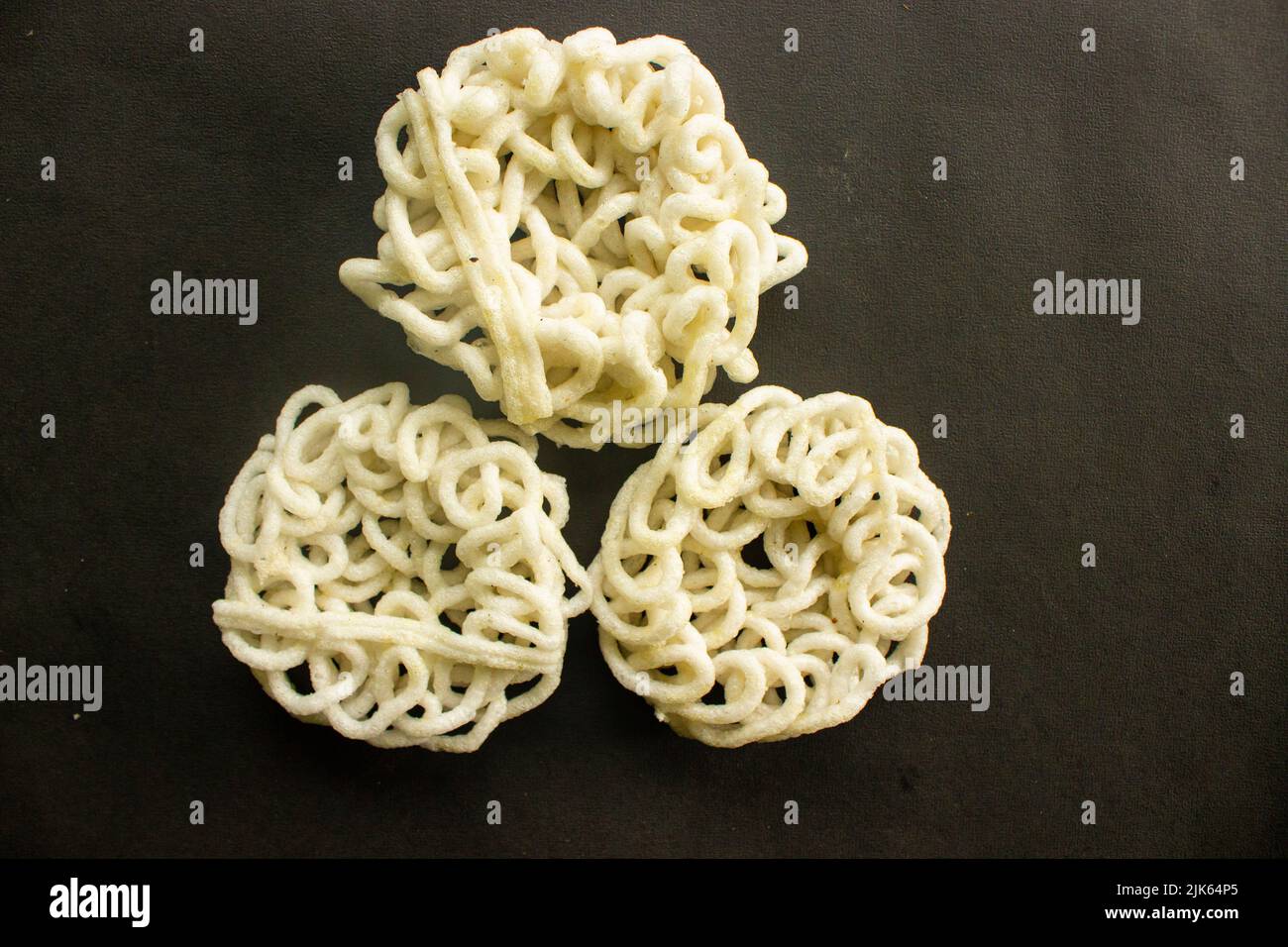 kerupuk or krupuk or crackers isolated on black background. kerupuk is snacks made from tapioca flour dough mixed with flavorings such as shrimp or fi Stock Photo