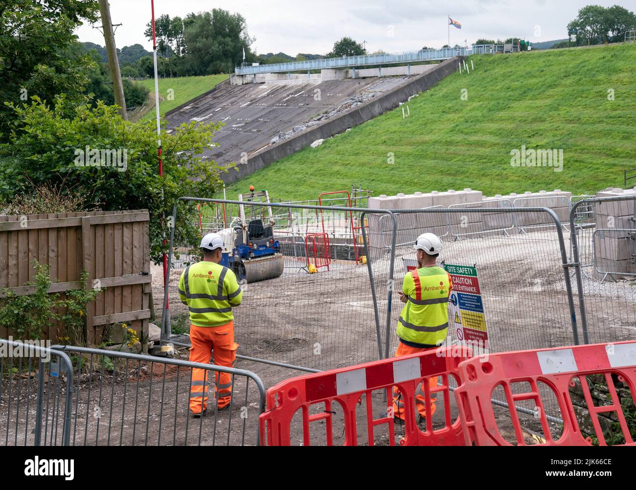 Workers near the dam at Toddbrook Reservoir in Derbyshire ahead of the third anniversary on August 1 of the dam being damaged in heavy rainfall. Picture date: Friday July 29, 2022. The dam nearly burst and flooded the nearby village of Whaley Bridge causing the evacuation of residents from the village. Photo credit should read: Danny Lawson/PA Wire Stock Photo