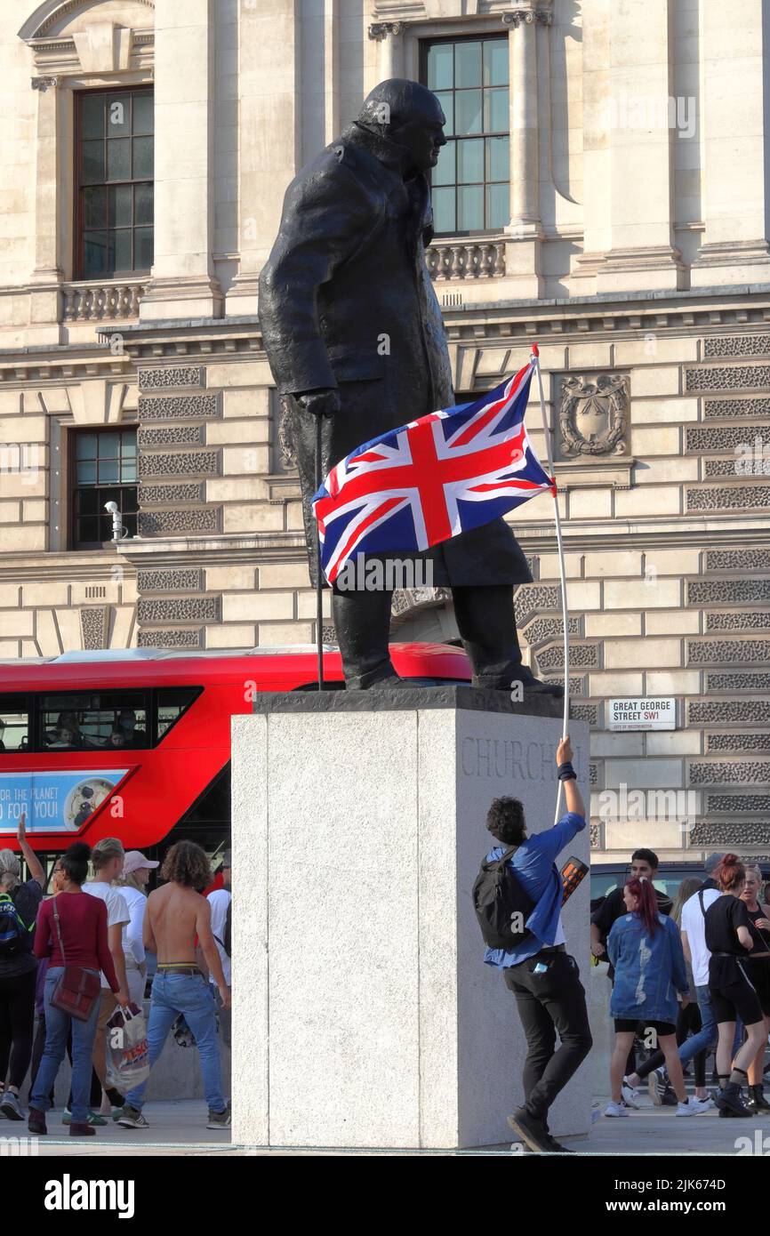 London, UK - September 19, 2020: Protester waving UK flag at the Winston Churchill statue Stock Photo