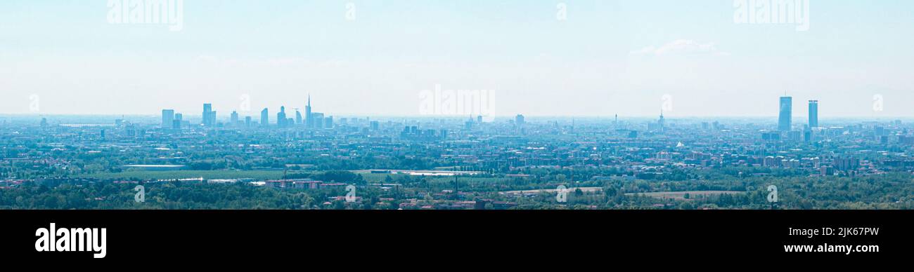 Aerial view of the new Skyline of Milan seen from the Milanese hinterland. Sky with mist that envelops the skyscrapers of the Lombard capital. Italy Stock Photo