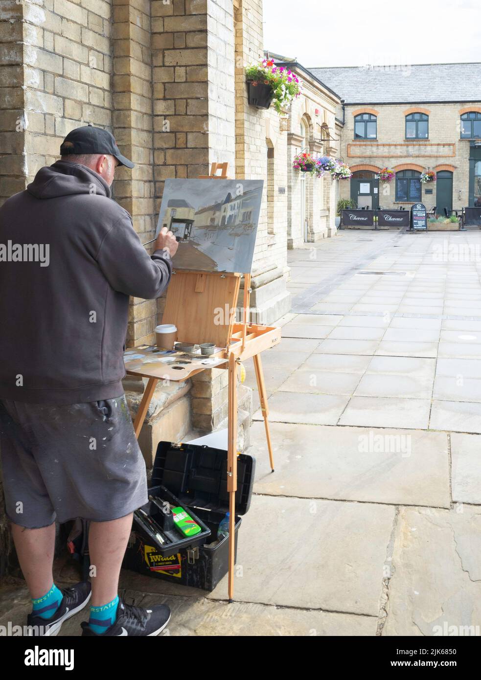 An artist painting at the railway station concourse at Saltburn North Yorkshire UK Stock Photo