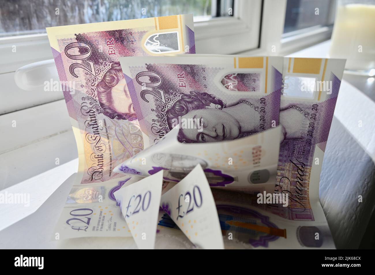 Discarded and crumpled twenty pound notes. Stock Photo