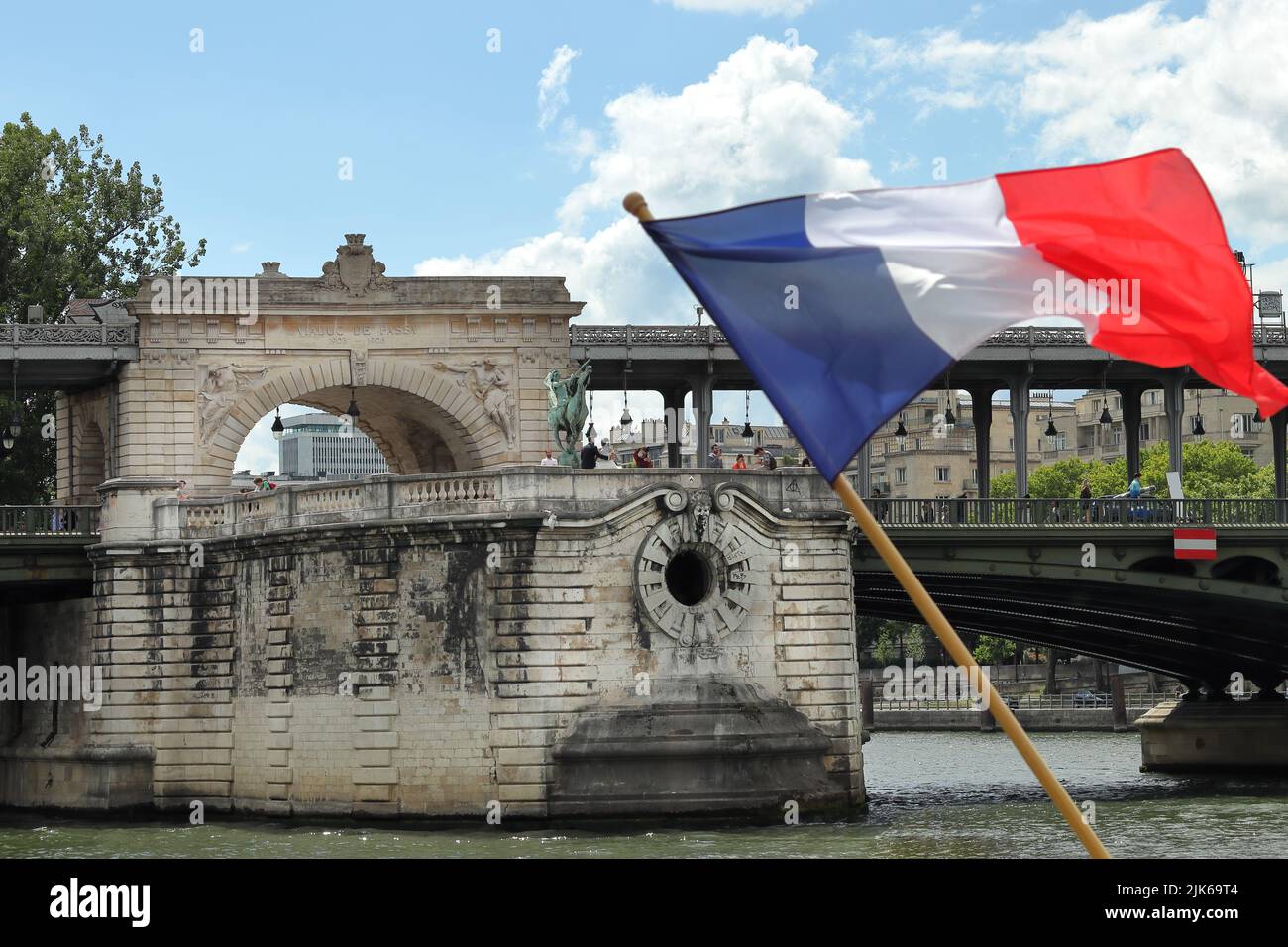 View of the Viaduc de Passy on Bir Hakeim bridge with French flag in the foreground Stock Photo