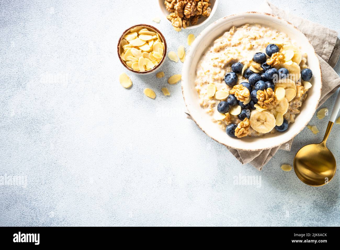 Oatmeal porrige in craft bowl at white background. Stock Photo