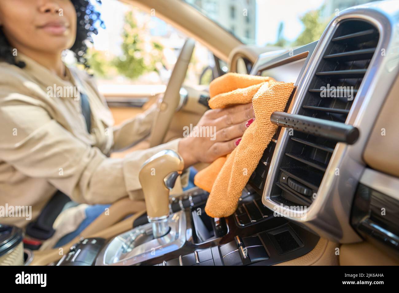 Woman wipes car interior with rag, hand auto wash Stock Photo by NomadSoul1