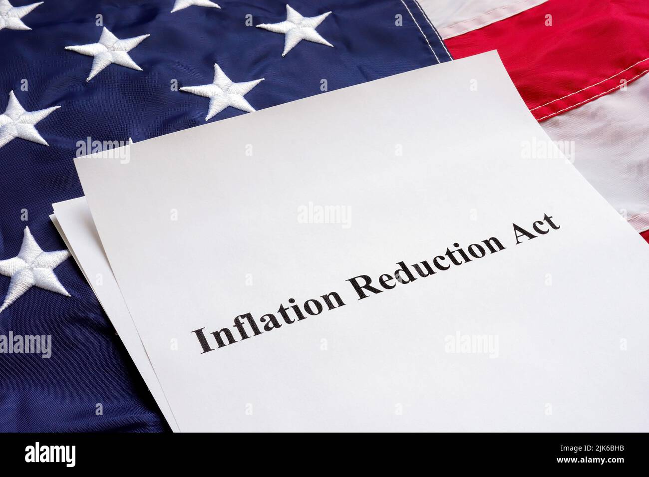 Papers with the Inflation Reduction Act and US flag. Stock Photo