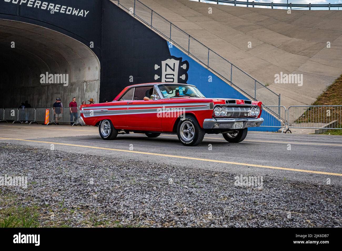 Lebanon, TN - May 14, 2022: Wide angle front corner view of a customized 1964 Mercury Comet Caliente Hardtop Sedan leaving a local car show. Stock Photo