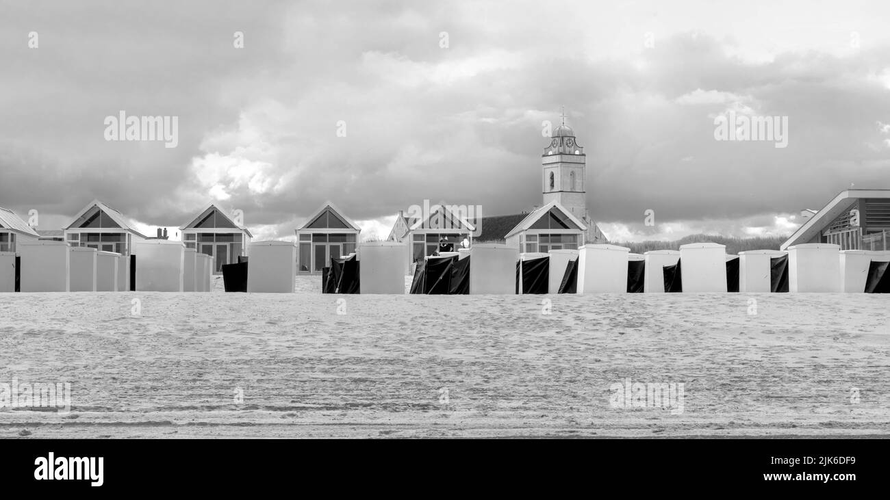 View from the beach of chalets and beach huts and Andrew's Church in Katwijk, South Holland, The Netherlands. Stock Photo