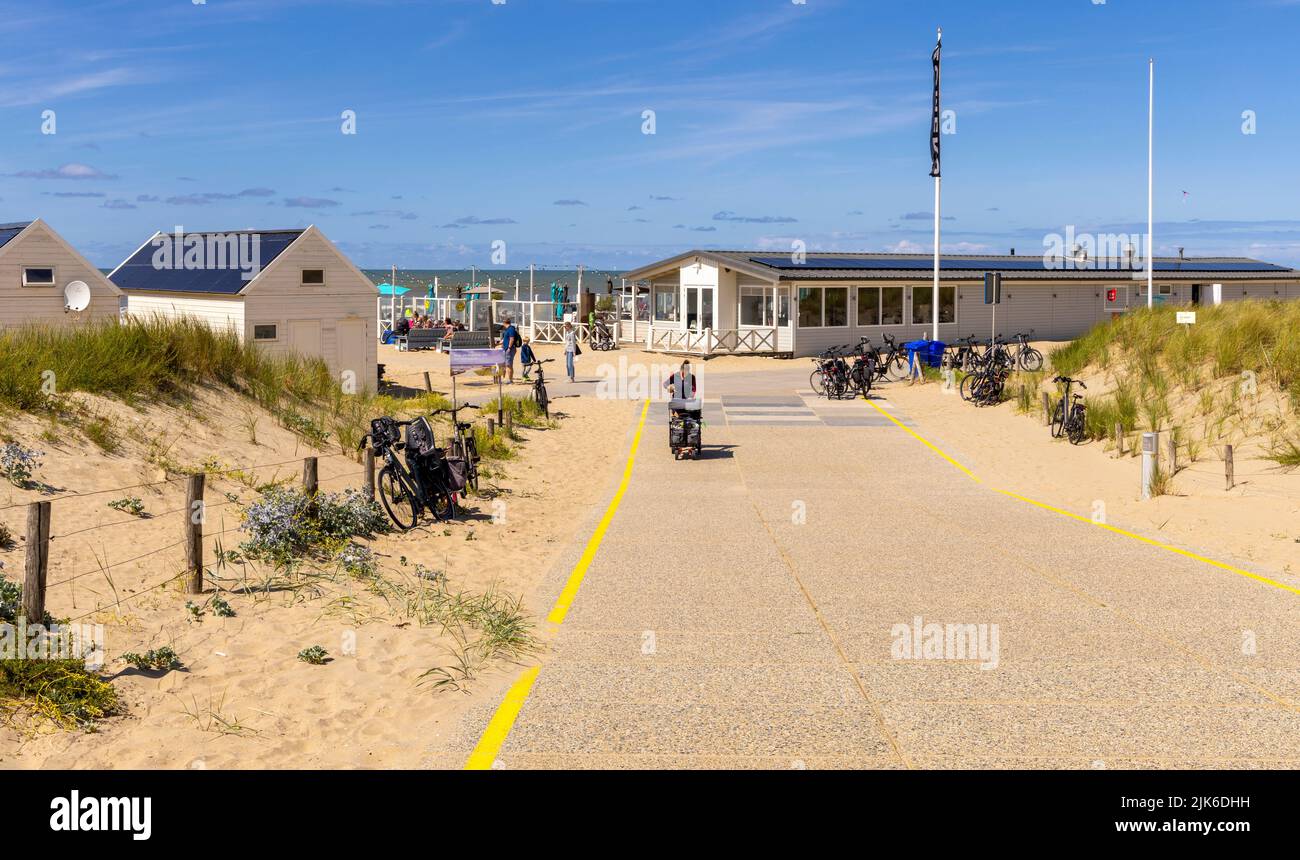 Footpath leading to beach chalets and pavilion with view of the North Sea in the background, Katwijk, South Holland, The Netherlands, Stock Photo