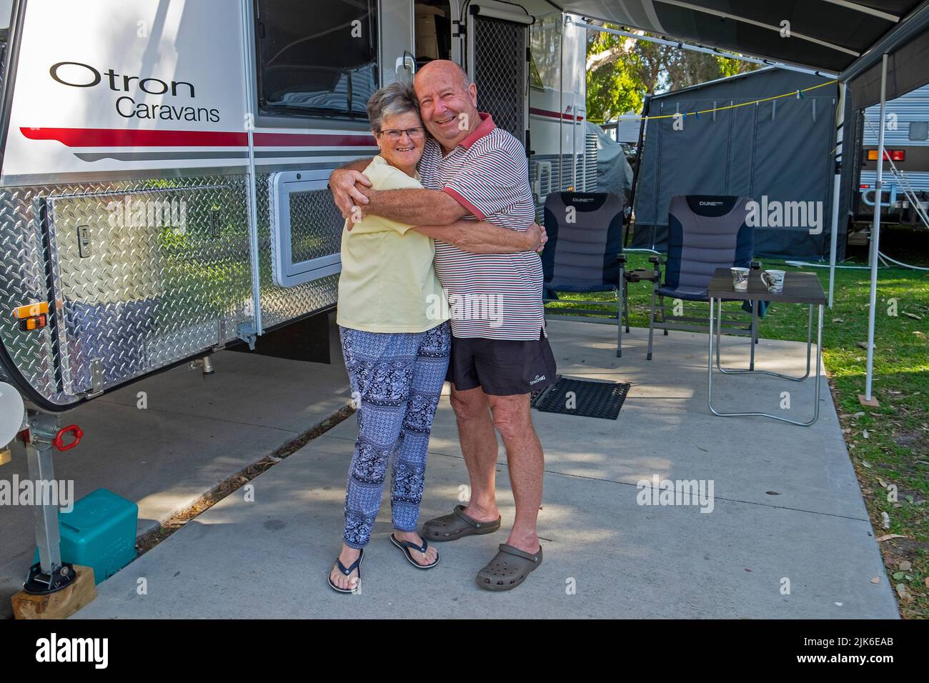 Happy retired couple camping with their luxury caravan at Mudkimba Caravan Parl in Queensland Stock Photo