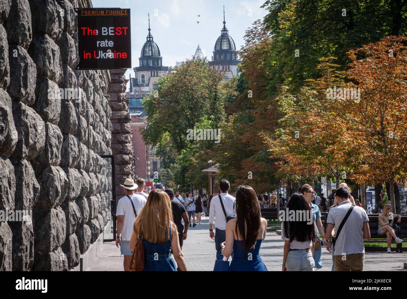 people-walk-under-a-currency-exchange-office-in-central-kyiv-russian