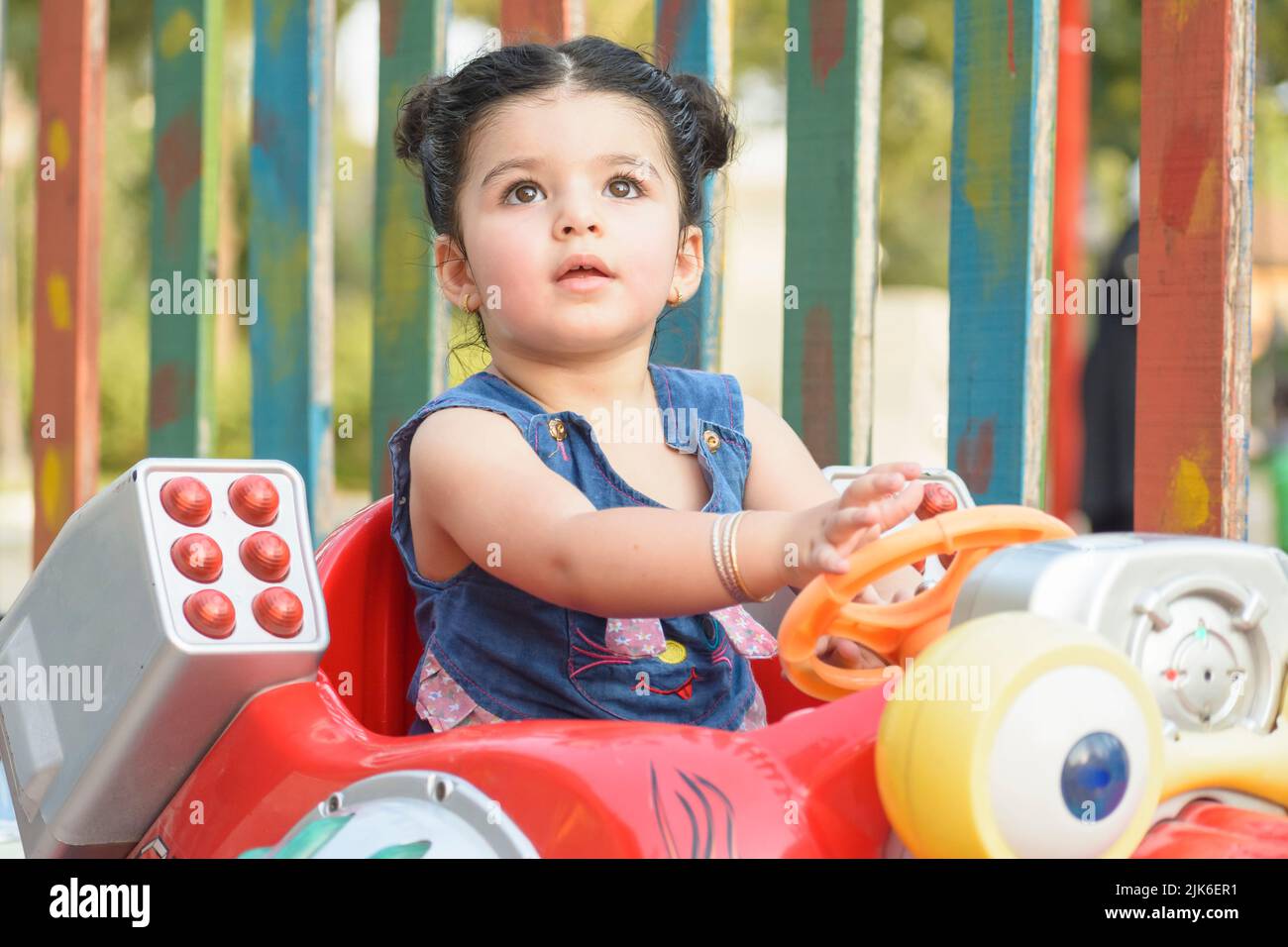 Little girl having fun on musical coin machine Stock Photo - Alamy