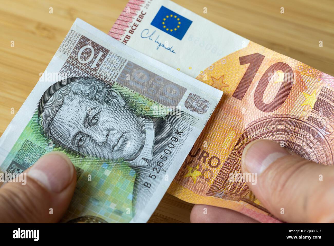 10 euro banknote and 10 kuna in hand, Exchange of Croatian Kuna into euro, Croatia's entry into the Eurozone Stock Photo