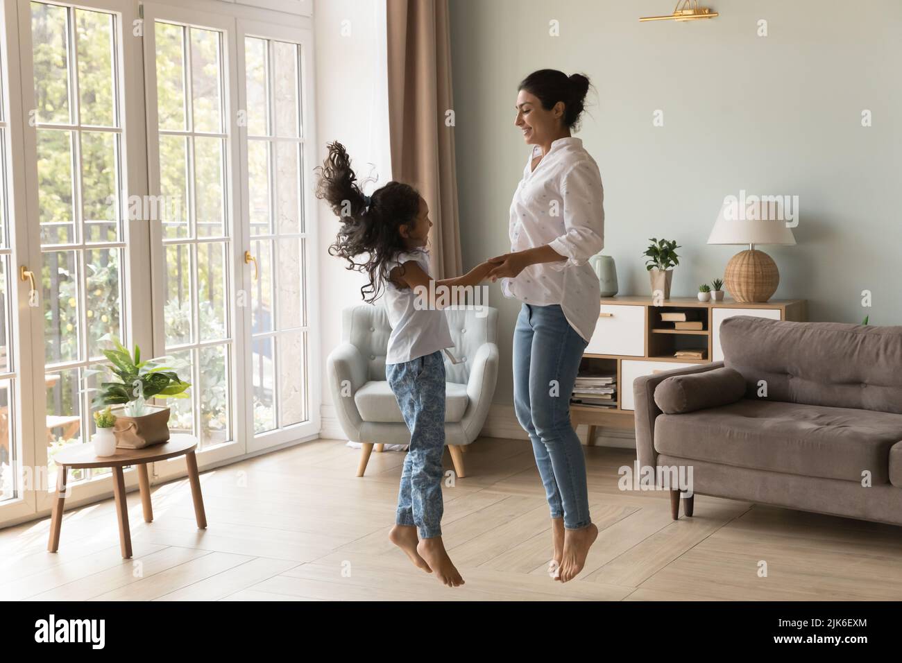 Excited Indian kid and happy mom holding hands Stock Photo