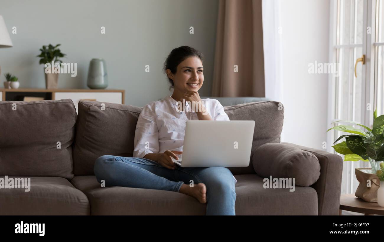 Happy pretty Indian laptop user girl working at laptop Stock Photo