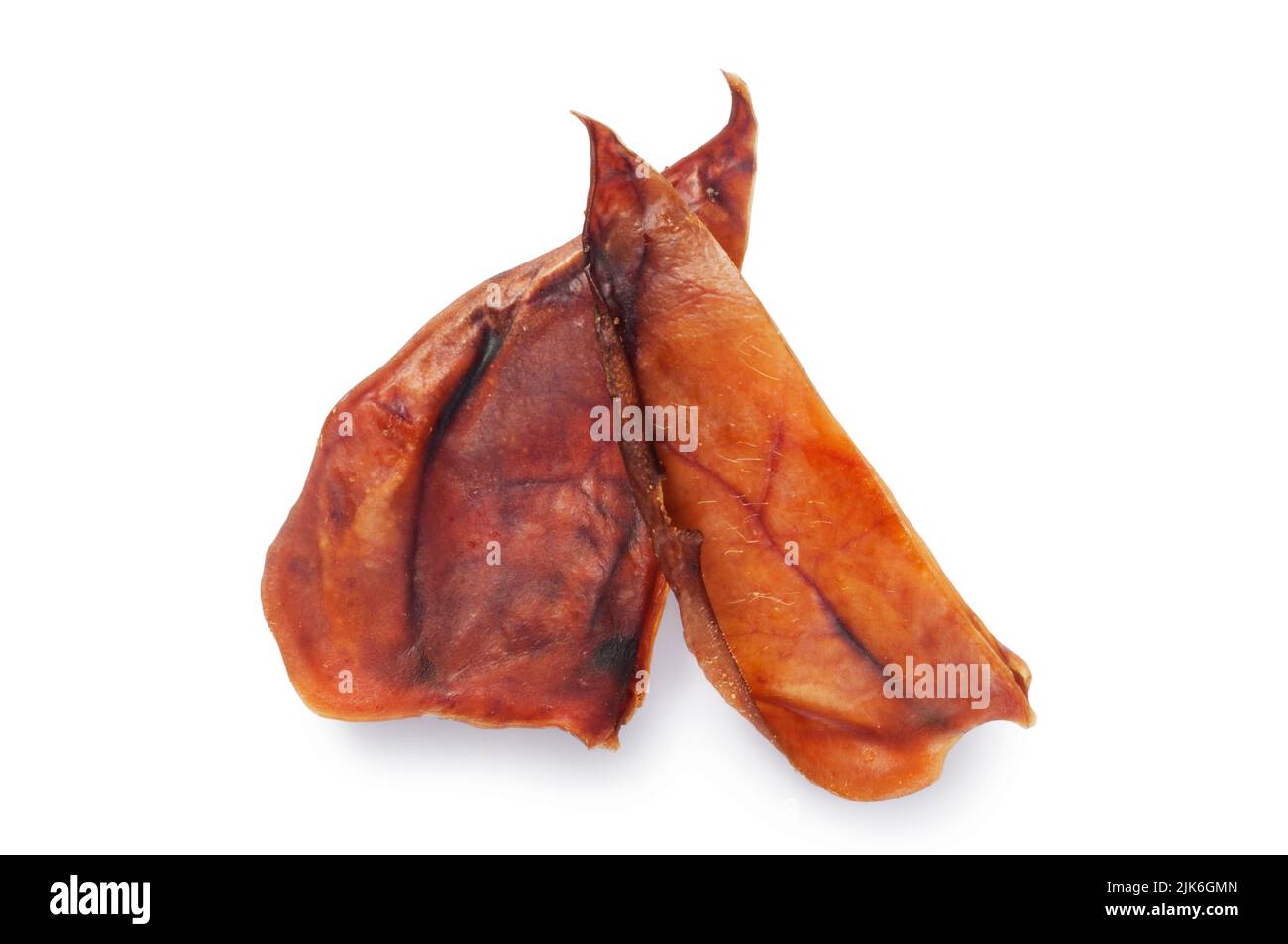 Studio shot of pigs ears, commonly used as a dog treat, cut out against a white background - John Gollop Stock Photo