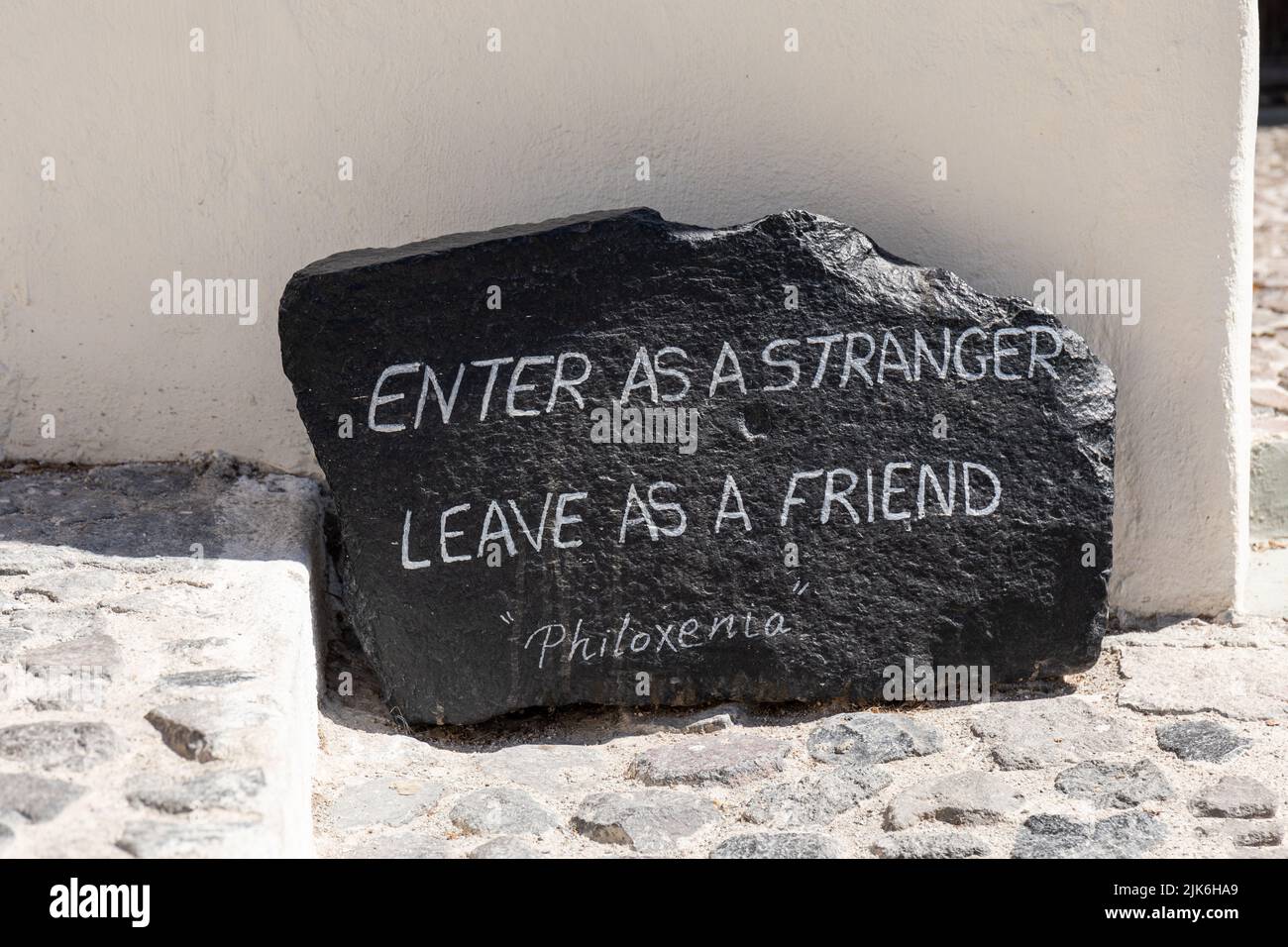 Enter as a Stranger leave as a Friend - Philoxenia, A welcome message  in Pyrgos Village, Santorini, Greece, Europe Stock Photo