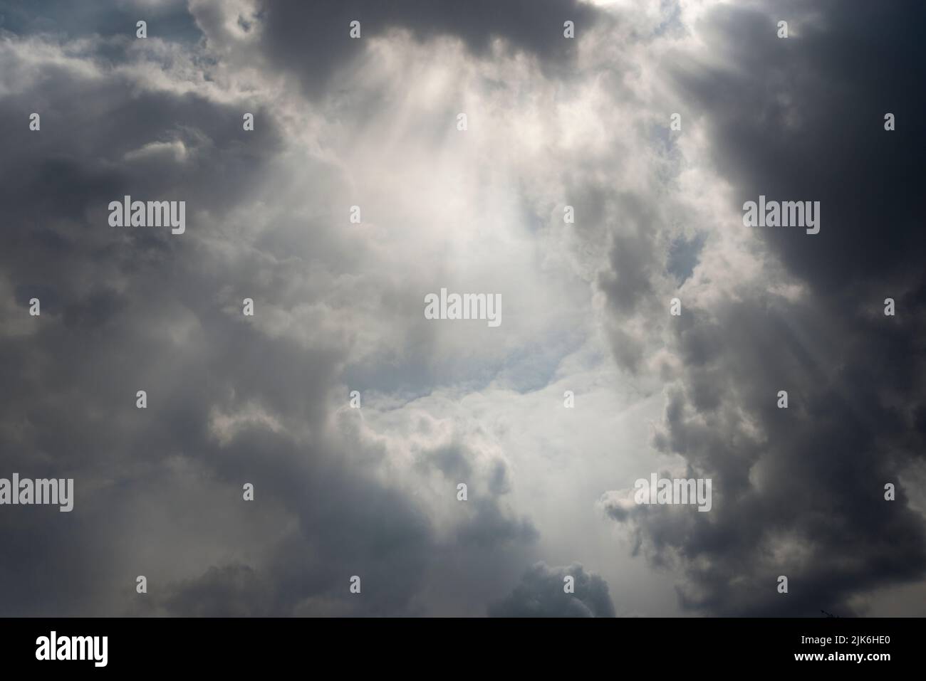 Storm clouds gathering with rays of the sun breaking through Stock Photo
