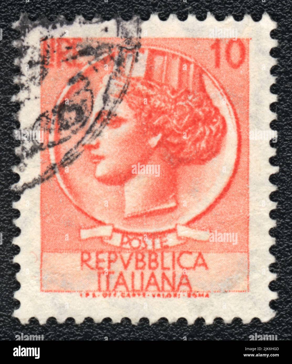 A stamp printed in Italy shows  Woman head, Italian Republic, in red color, 10 Lire, circa 1980 Stock Photo