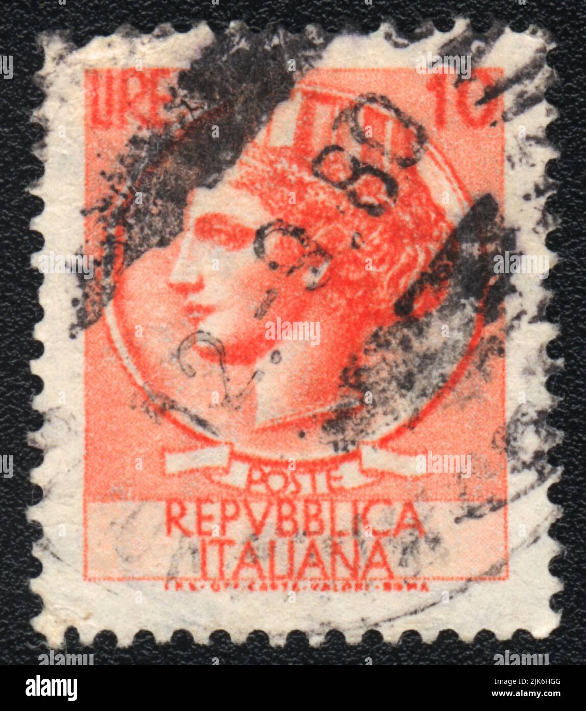 A stamp printed in Italy shows  Woman head, Italian Republic, in red color, 10 Lire, circa 1980 Stock Photo