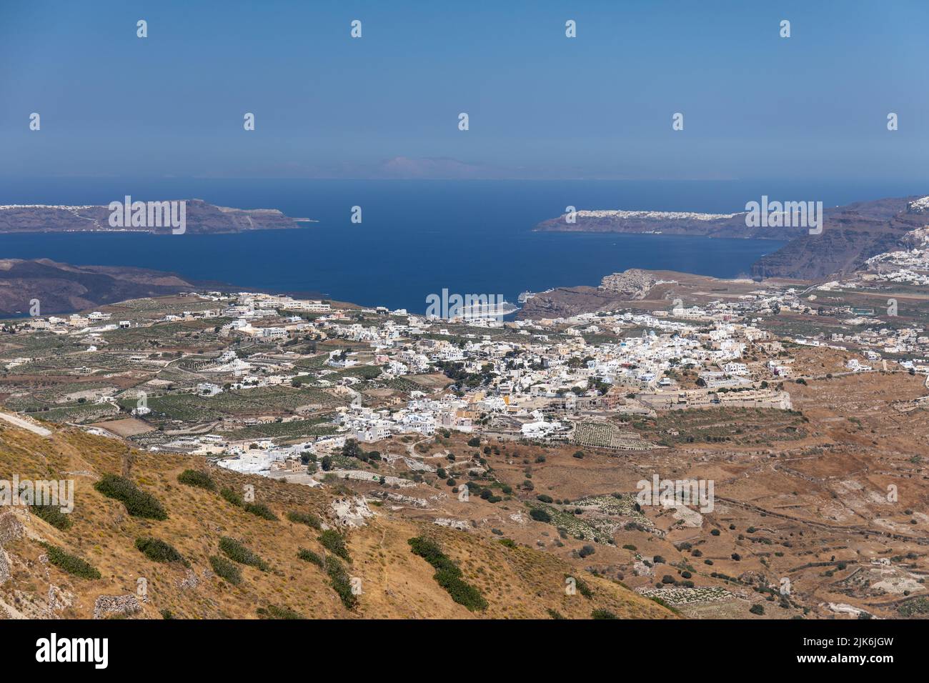 View from The Holy Orthodox Monastery of Prophet Elias on the summit of Mount Profitis Ilias of Fira town and Thira volcanic landscape, Greece, EU Stock Photo