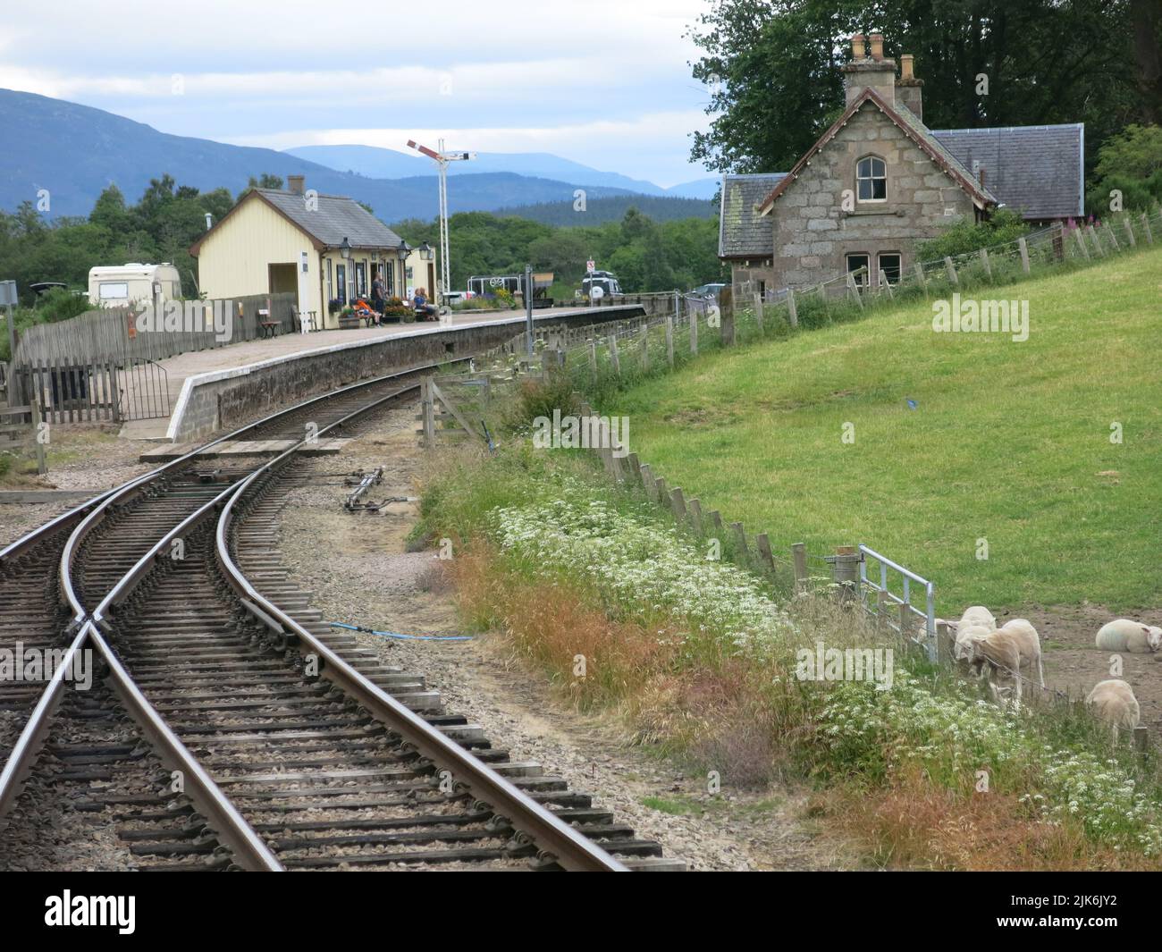 View of the railway line and one of the stations on the heritage steam Strathspey Railway which runs through the Scottish Highlands from Aviemore. Stock Photo