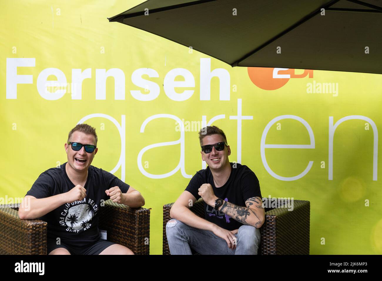 Mainz, Germany. 31st July, 2022. The hit duo DJ Robin (r) & Schürze, the performers of the song 'Layla', are sitting on stage in the 'ZDF-Fernsehgarten'. For weeks there has been a sexism debate about their song. On Sunday, the 'Fernsehgarten' was held under the party motto 'Mallorca vs. Credit: Hannes P. Albert/dpa/Alamy Live News Stock Photo