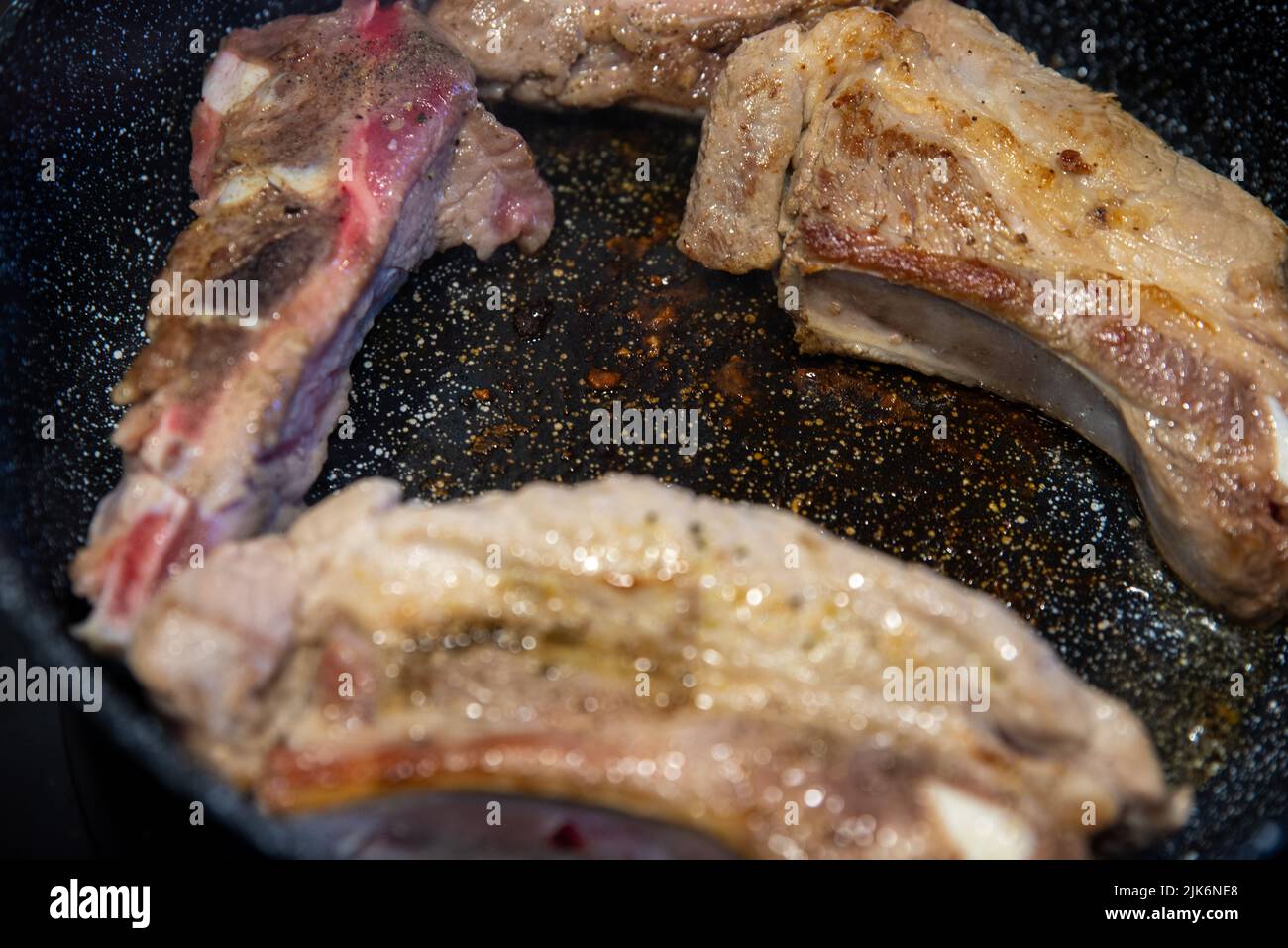unhealthy frying meat on a damaged coating in a pan Stock Photo Alamy