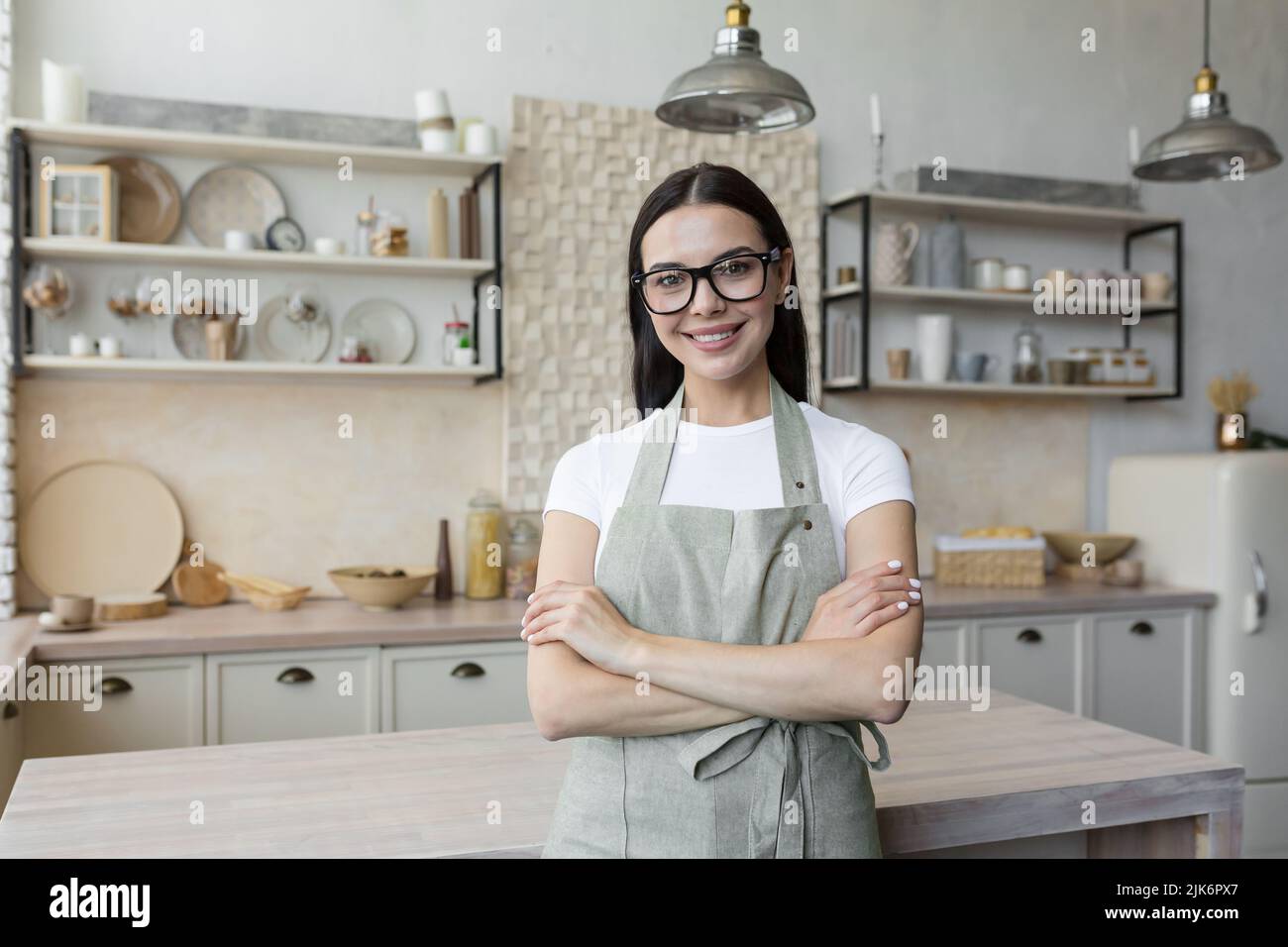 Woman wearing apron in kitchen hi-res stock photography and images - Alamy