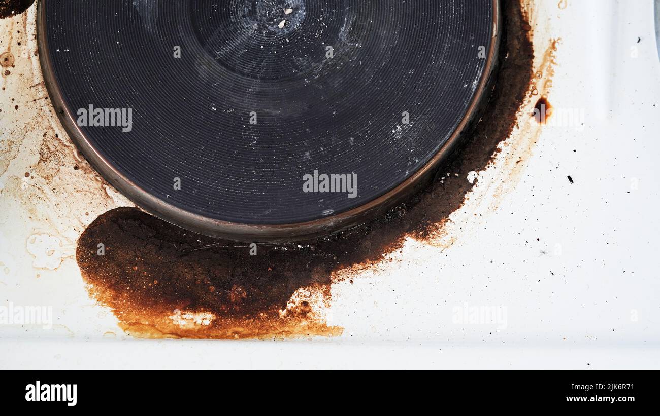 Closeup of a dirty stove with leftover food. Dirty gas stove with