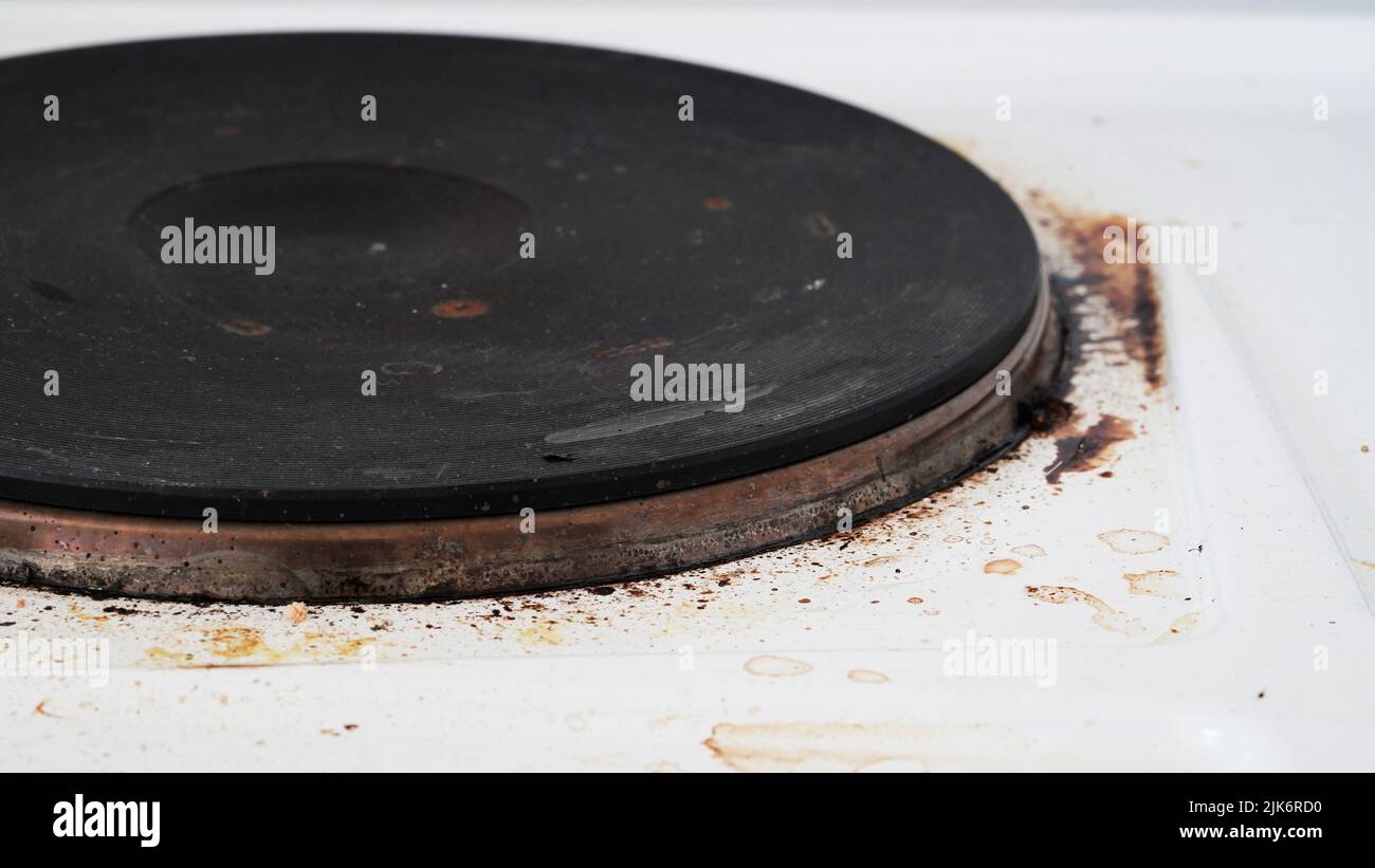 Closeup of a dirty stove with leftover food. Dirty gas stove with