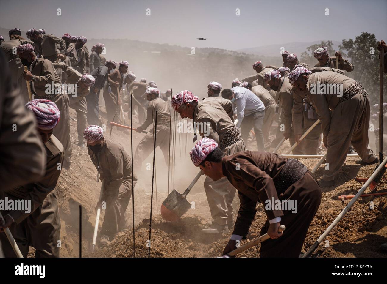 Barzan, Iraq. 31st July, 2022. Kurdish men dig graves at the Anfal