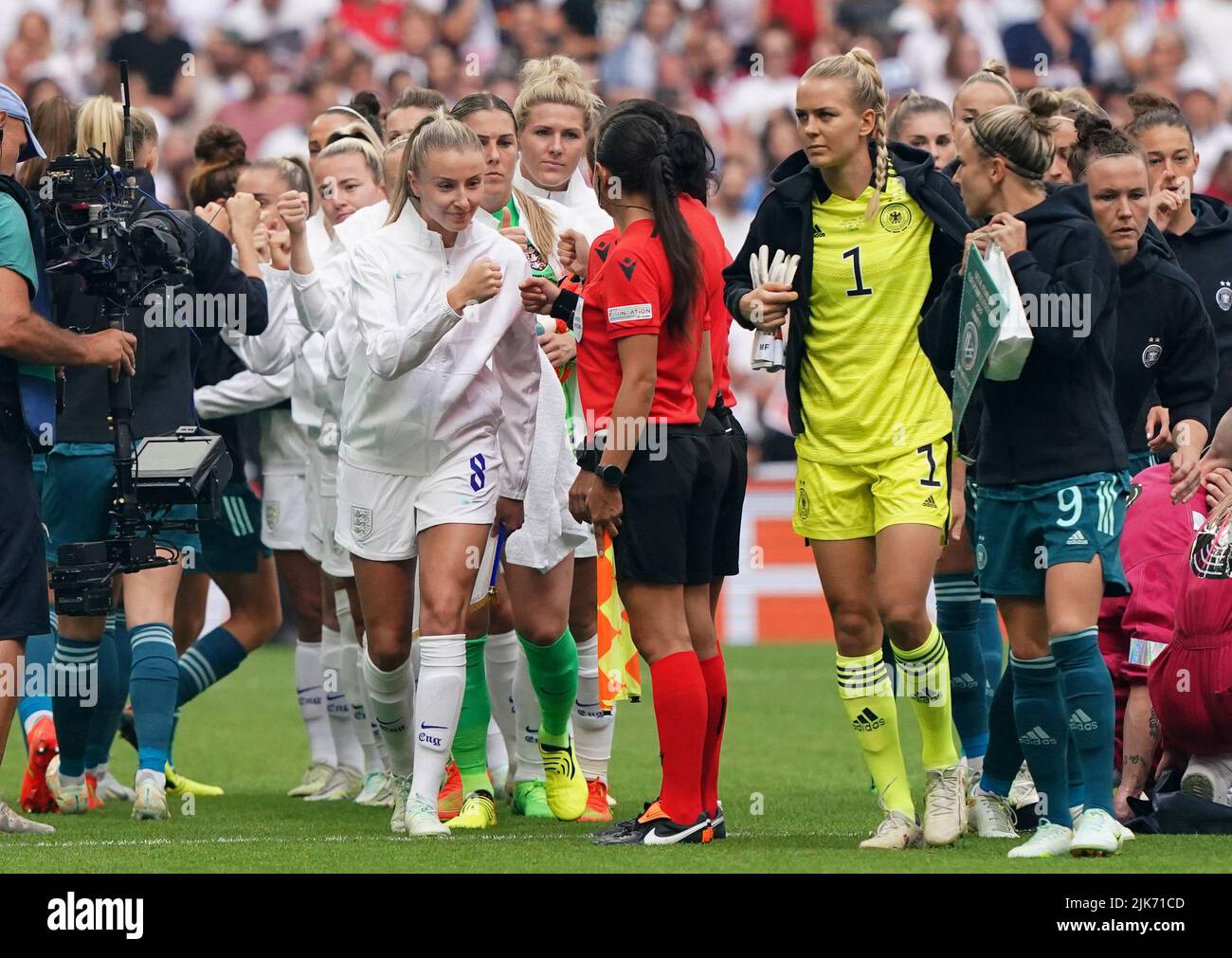 England's Leah Williamson (centre) bump fists with the match officials before the UEFA Women's Euro 2022 final at Wembley Stadium, London. Picture date: Sunday July 31, 2022. Stock Photo
