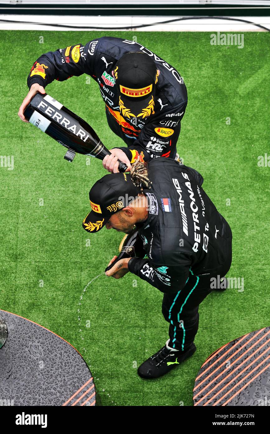 Race winner Max Verstappen (NLD) Red Bull Racing celebrates with second placed Lewis Hamilton (GBR) Mercedes AMG F1 on the podium. Hungarian Grand Prix, Sunday 31st July 2022. Budapest, Hungary. Stock Photo