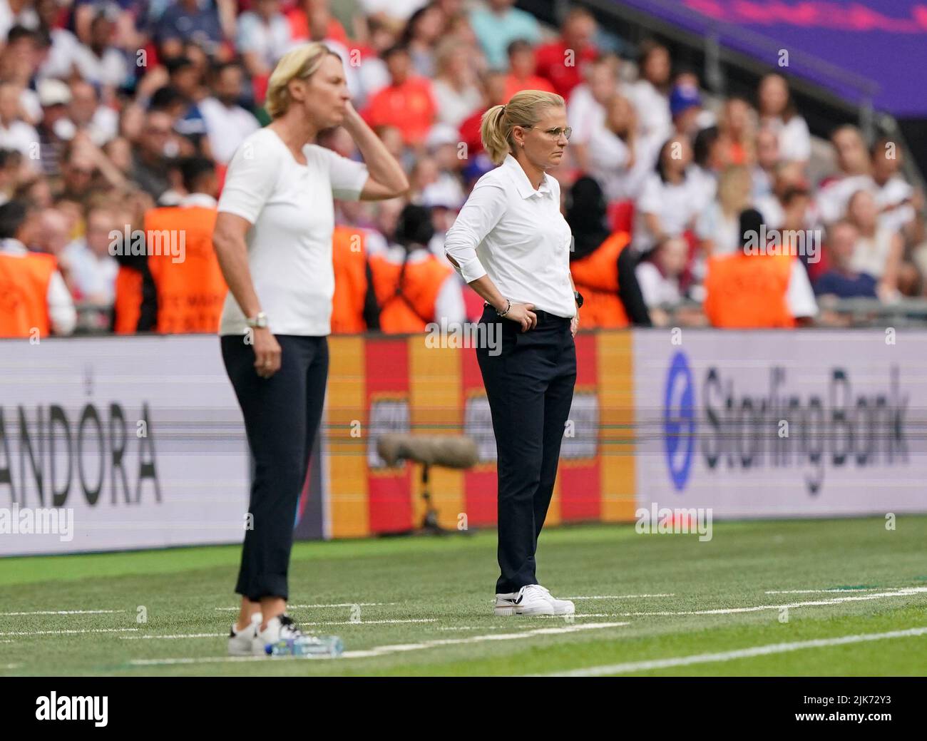 England head coach Sarina Wiegman (right) on the touchline with Germany head coach Martina Voss-Tecklenburg during the UEFA Women's Euro 2022 final at Wembley Stadium, London. Picture date: Sunday July 31, 2022. Stock Photo