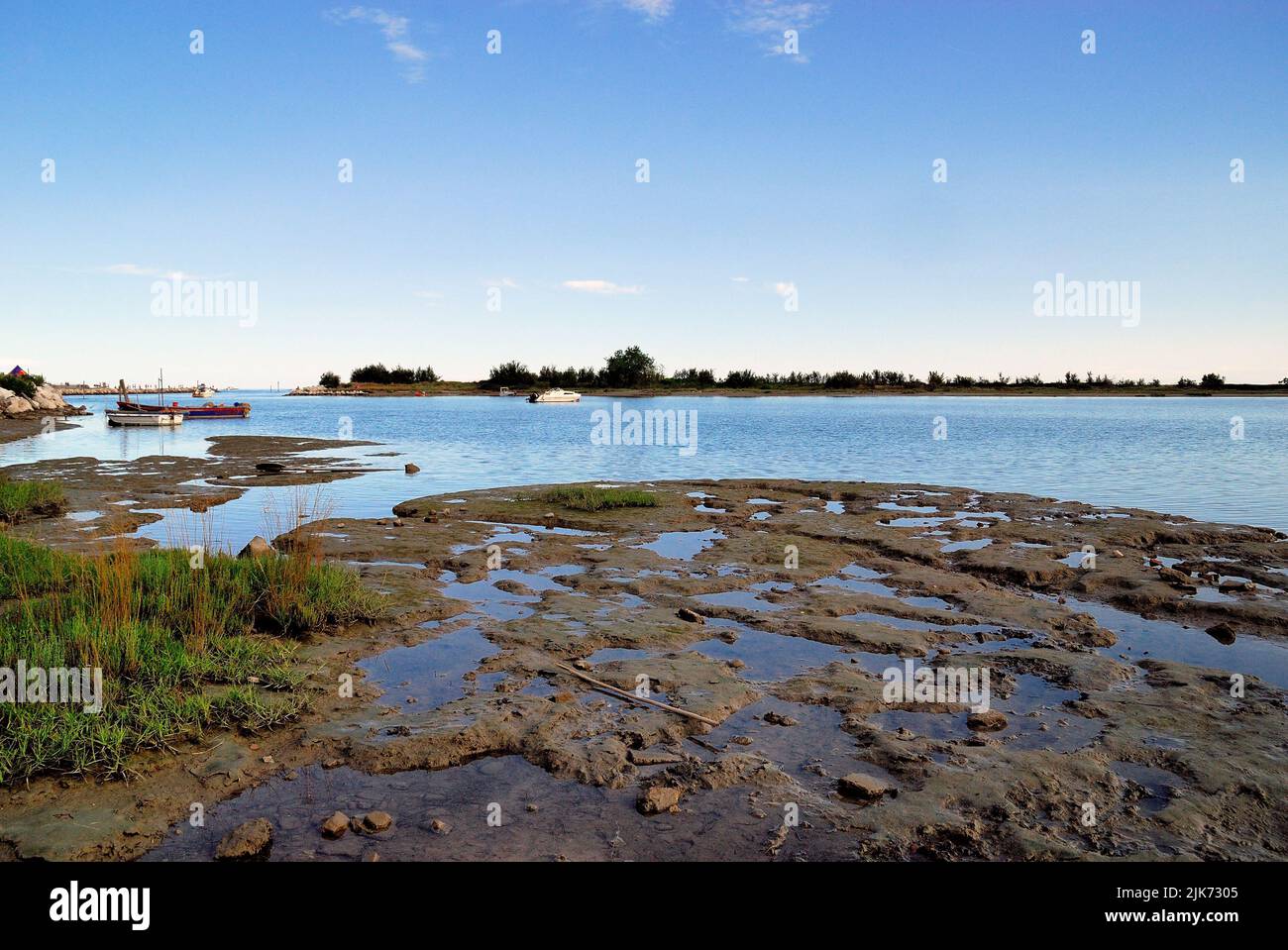 Veneto, Italy, The Laguna del Mort (En. Dead Man Lagoon). It is located at the mouth of the Piave river. The lagoon is characterized by shallow and calm waters with shallow and sandy bottoms rich in phytoplankton, where mussels, clams, oysters, crabs, mullets, plaice and sole live, there are numerous water birds. Stock Photo