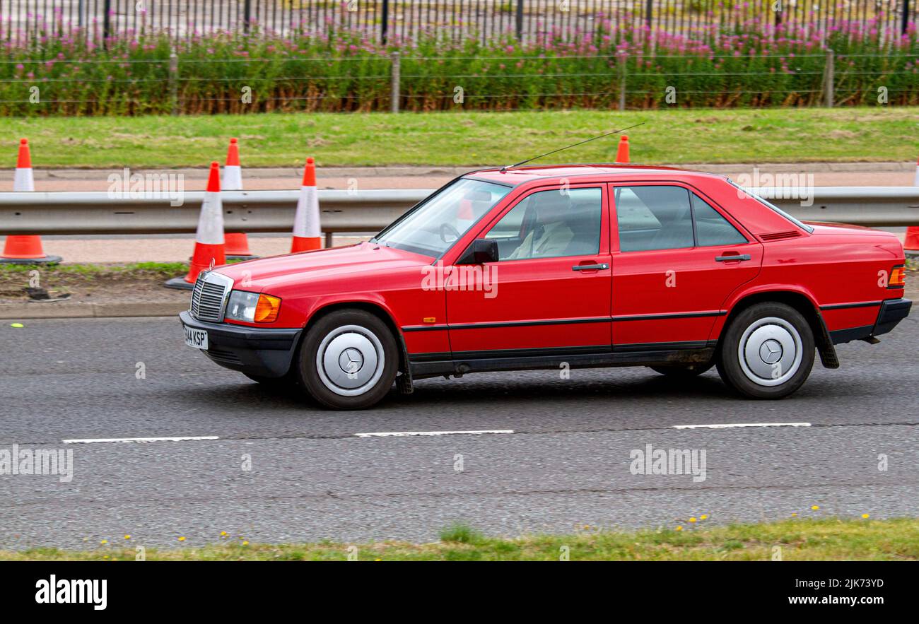 An August 1987- July 1988 red Mercedes Benz car motoring along the Kingsway West Dual Carriageway in Dundee, UK Stock Photo