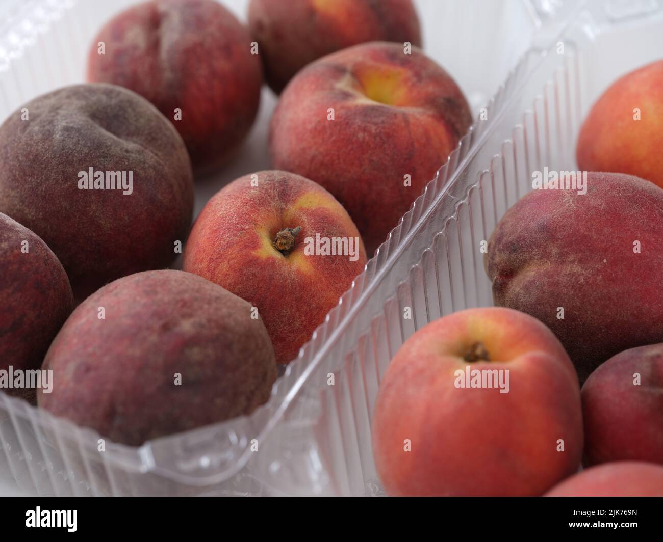 Peaches in plastic containers. Close up. Stock Photo